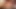 Redhead ladyboy in red dress strokes her shaved cock in the