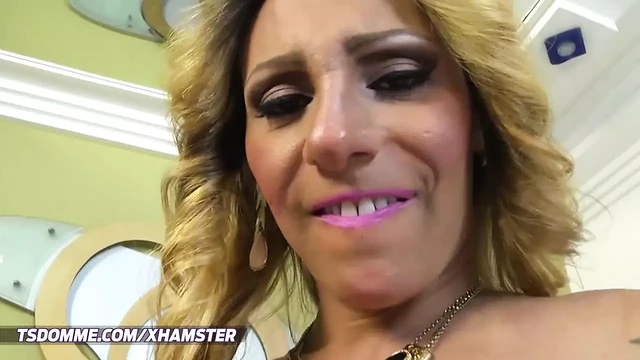 Feminine blonde tranny in pink bikini gets her big cock