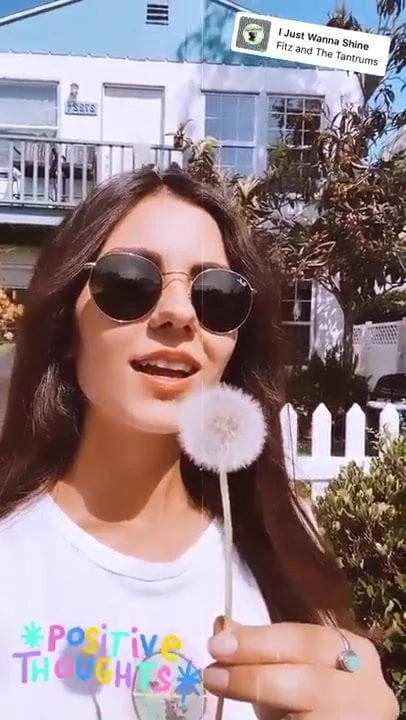 Victoria Justice with a dandelion