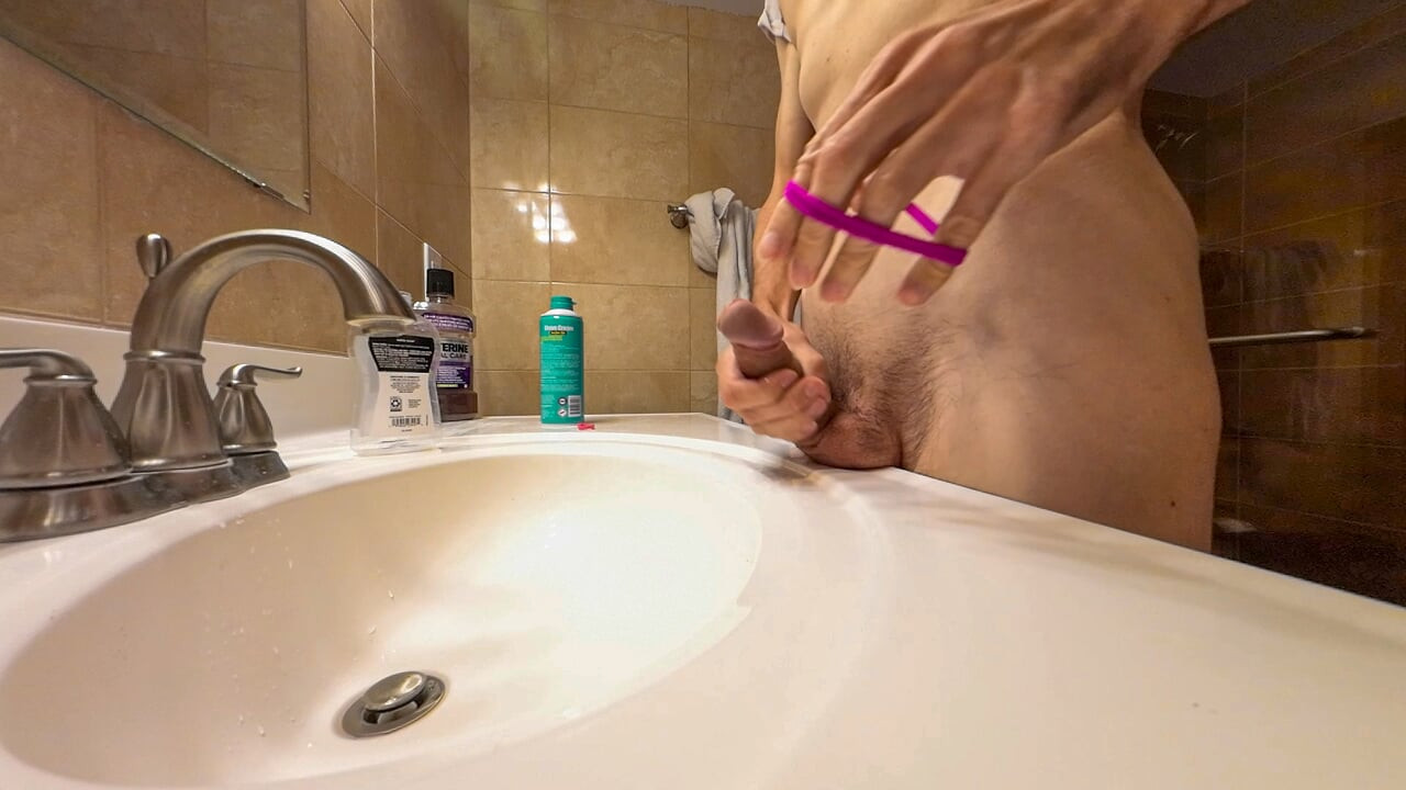 Skinny muscular amateur guy hard jerking off his huge uncut cock and put rubber band on his balls to take cumshot lot of sperm