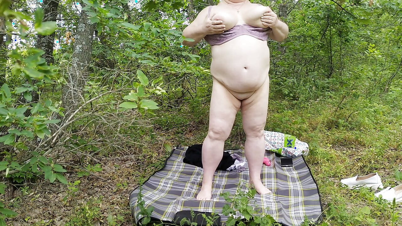 Mother-in-law undressed in a public park and masturbates her big pussy