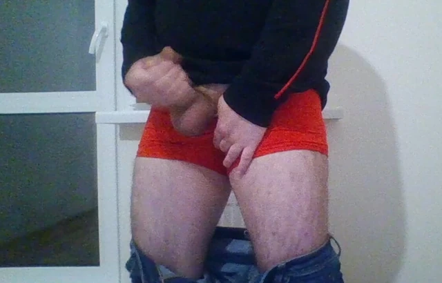 Young guy Andrew is jerking his cock by the window while he is alone