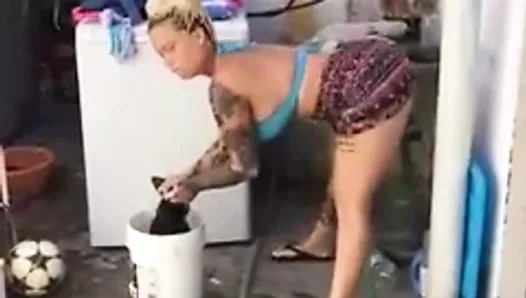 sexy lady dancing while washing clothes