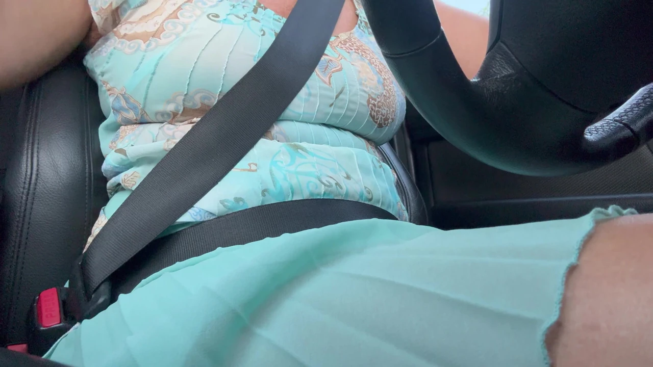 An elegant lady drives to work and rubs her pussy with her hand between her hot thighs