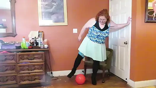 Nurse Vicki  plays with a rubber ball in a mini skirt, sexy stockings and high heel mini boots