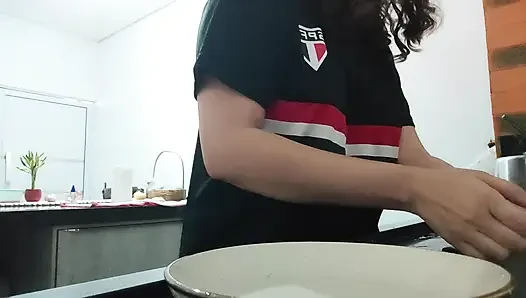 Woman teasing while washing dishes. She loves to transmit to the voyeurs on duty