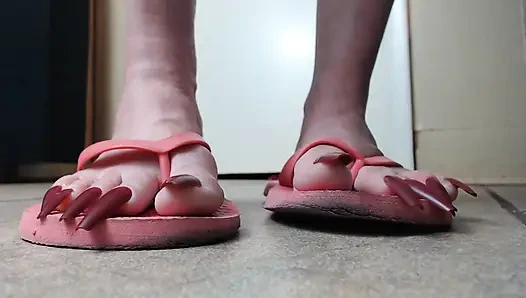 Long red toenails pink flipflops