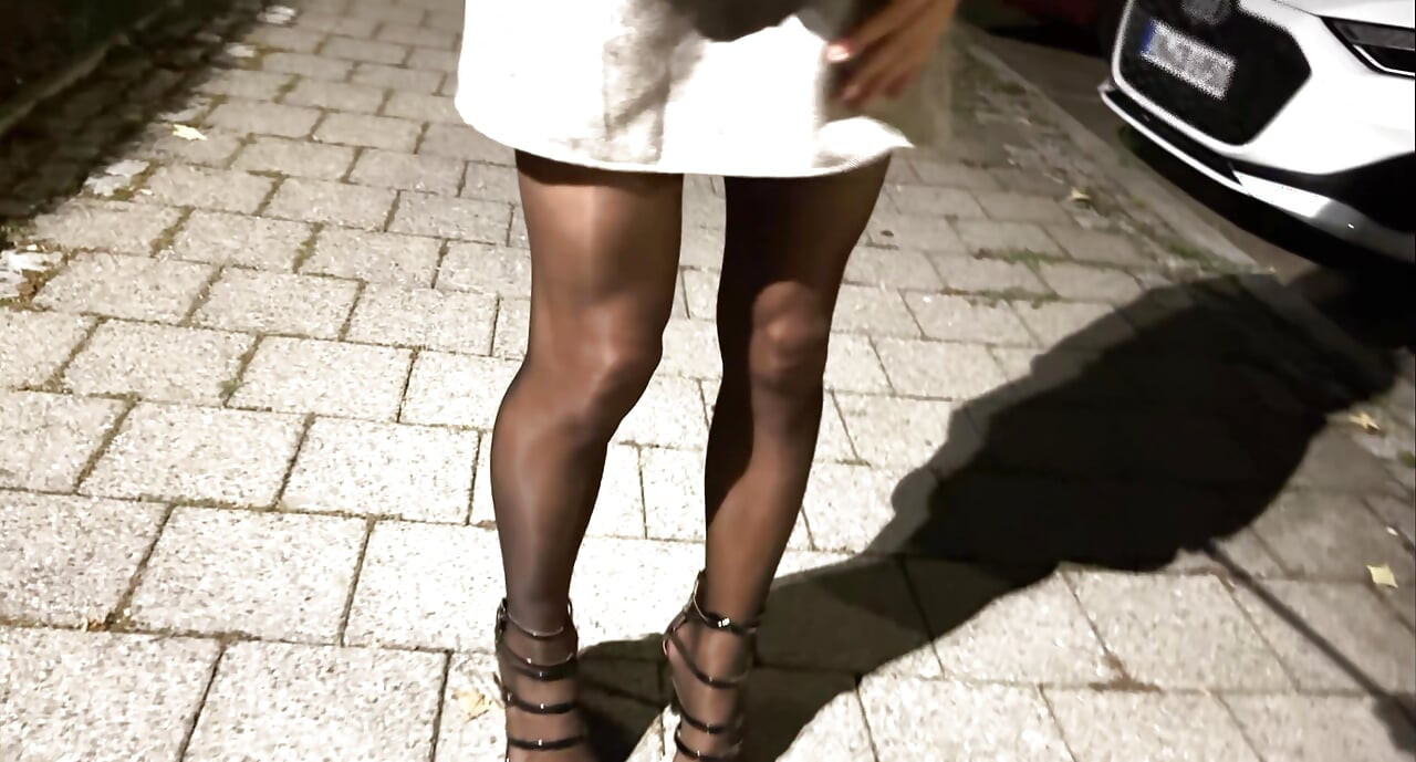 I'm dressed in a sexy business outfit, shiny pantyhose, and black stockings.