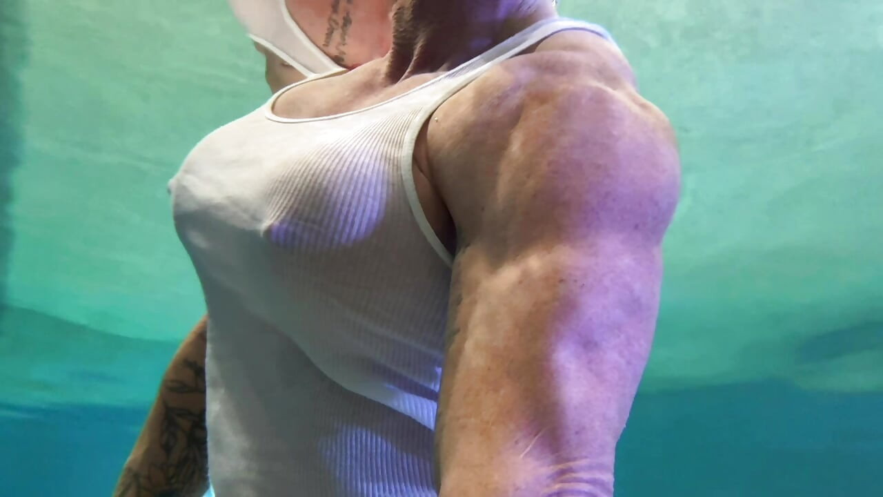 Amazon Kandy Flexes Her Massive Biceps in Her Hotel Pool