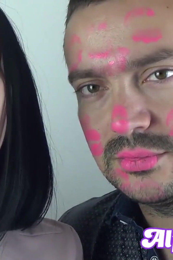 Covering Alex with pink neon shiny lipstick while kissing all over his face