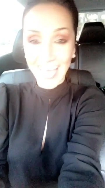 hot brunette talking and flashing in her car