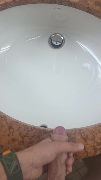 Secretly jerking off and cumming in the hotel bathroom while a friend can just walk in.