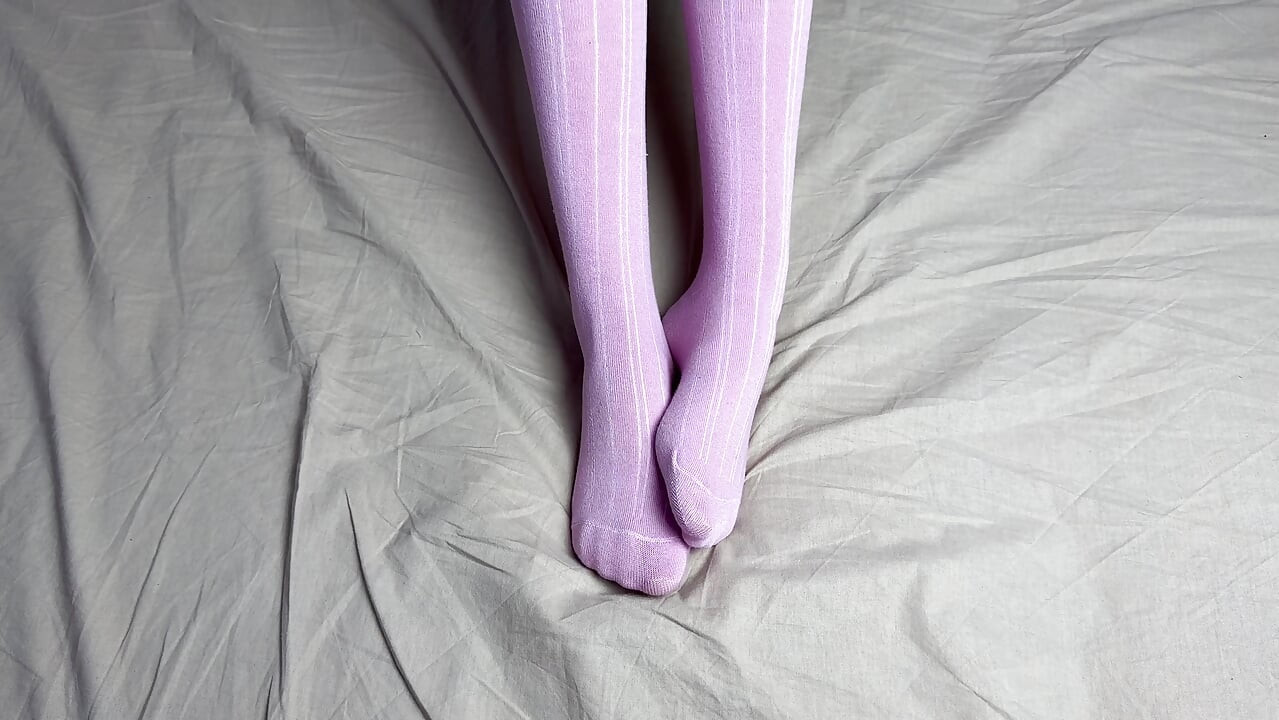 Pink socks in hands of mistress with blue nails in solo video