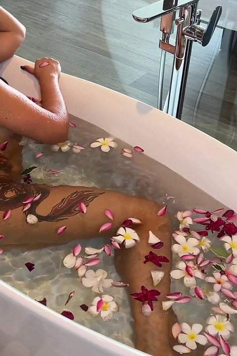 Bath of Blossoms Naked MILF Masturbates Among Flowers