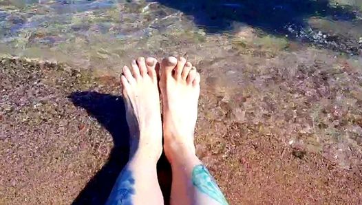 Dominatrix Nika enjoys the salty sea on her feet.