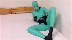 Jade and black rubber doll in total latex enclosure