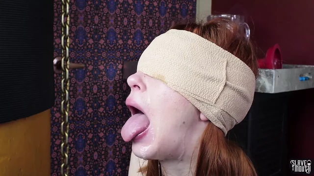 Blindfolded cum addicted redhead slave girl gagging on a cock