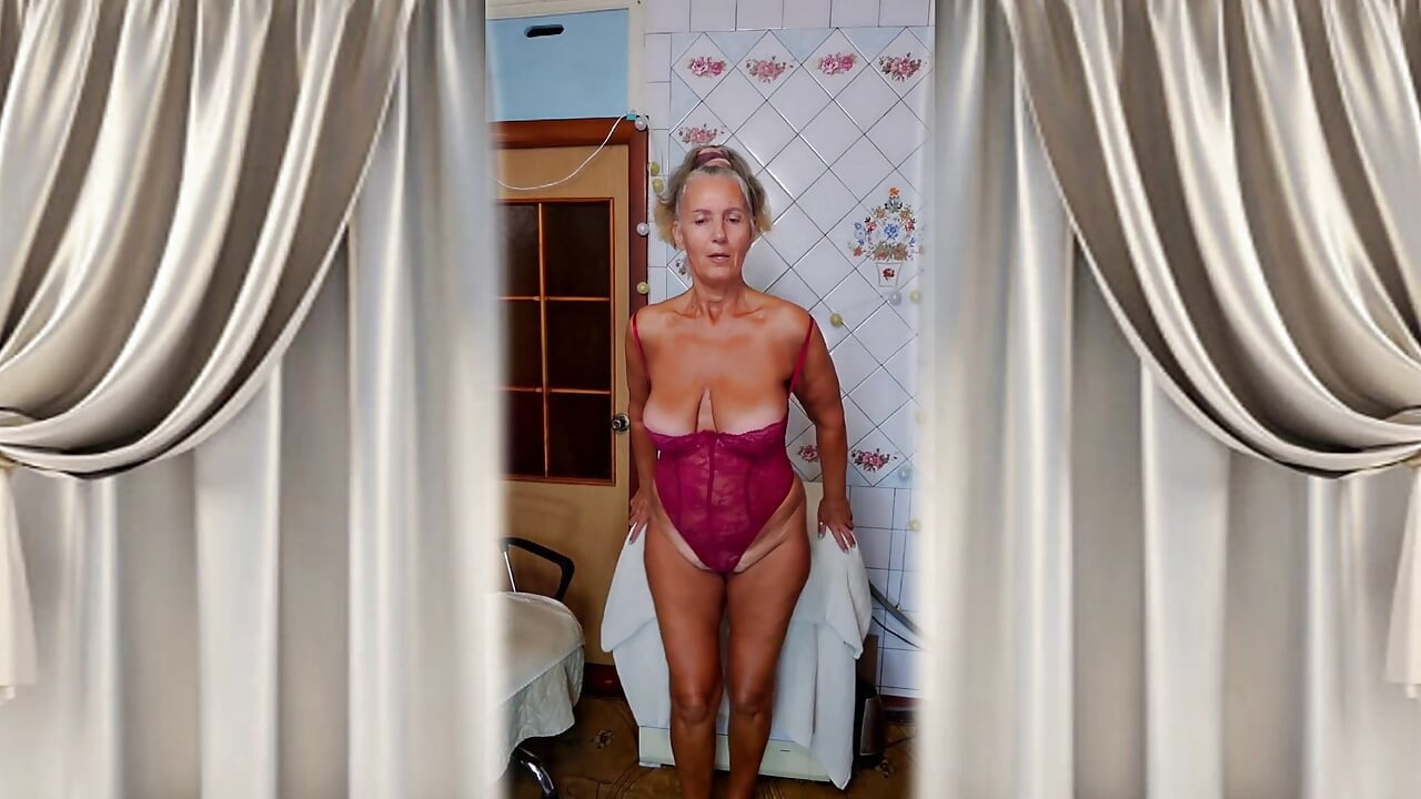 Cheerful housewife Lukerya changes clothes in the kitchen