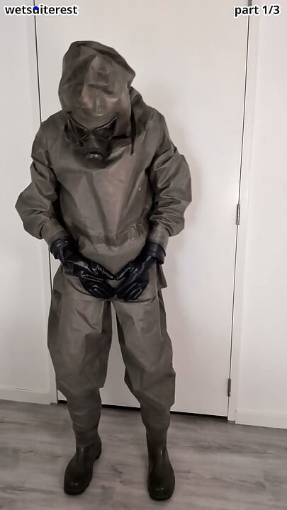Putting on Zodiac Zodiak heavy rubber hazmat suit over plastic pants and gas mask