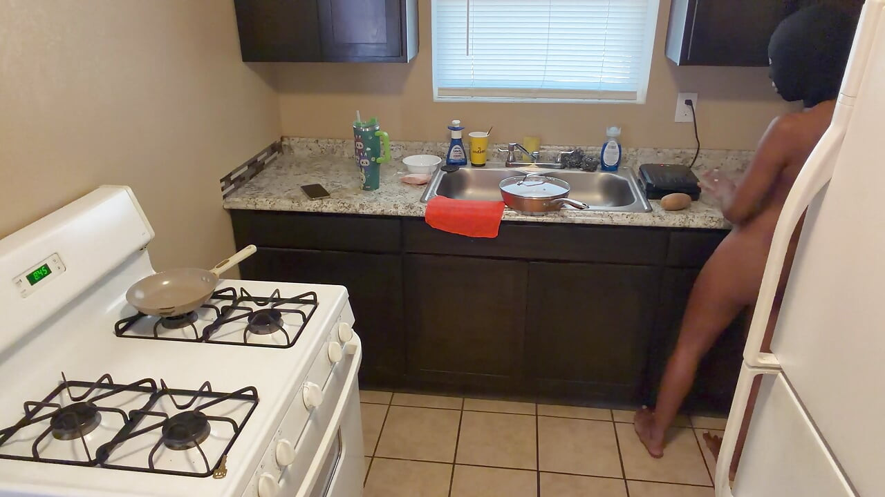 In the kitchen cooking and preparing food booty naked!