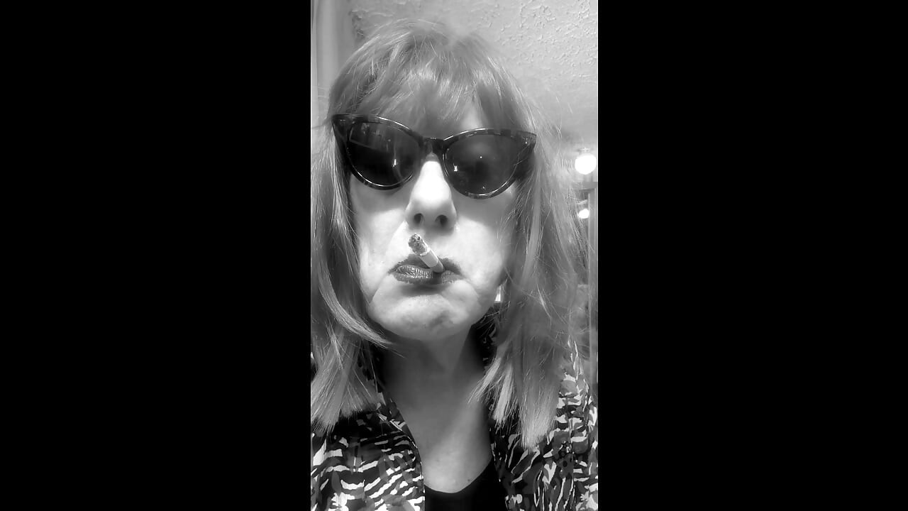 MRS. ROMAN DESTROYING A MARLBORO 100 MENTHOL CLOSE UP - WITH DANGLING AND NOSTRIL EXHALES