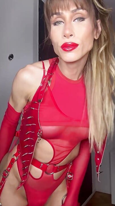 Blonde Trans in Red Latex BDSM Costume Dances