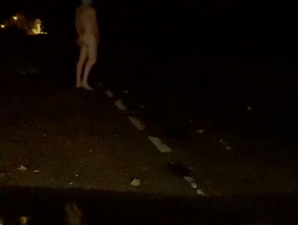 Naked in road and hiding the wrong side of road from safety when car passed