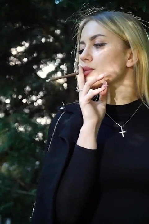 Hot Blonde Babe Smoking Two Black Cigarettes in Nature