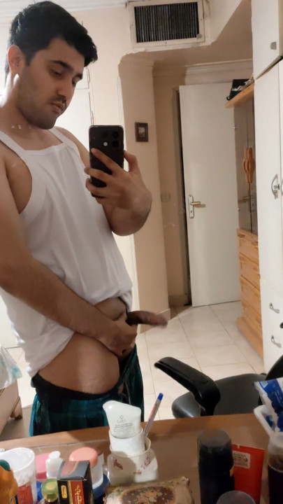 The Iranian boy shows him in front of the mirror and squeezes