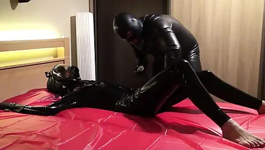 Oil body in latex catsuit