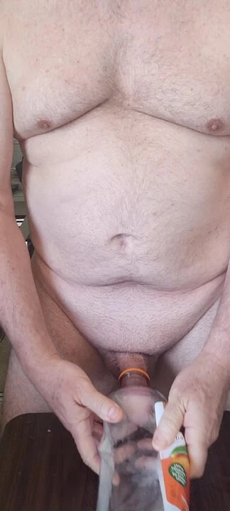 Exhibitionist masturbator testing a new bottle for cock play