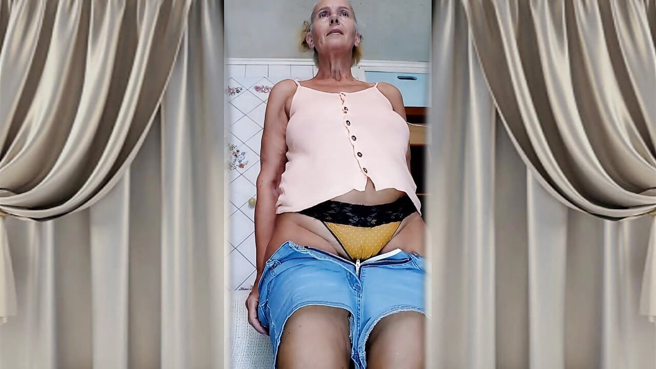 Cheerful old lady Lukerya. Alluring movements and shiny feet on the washing machine.
