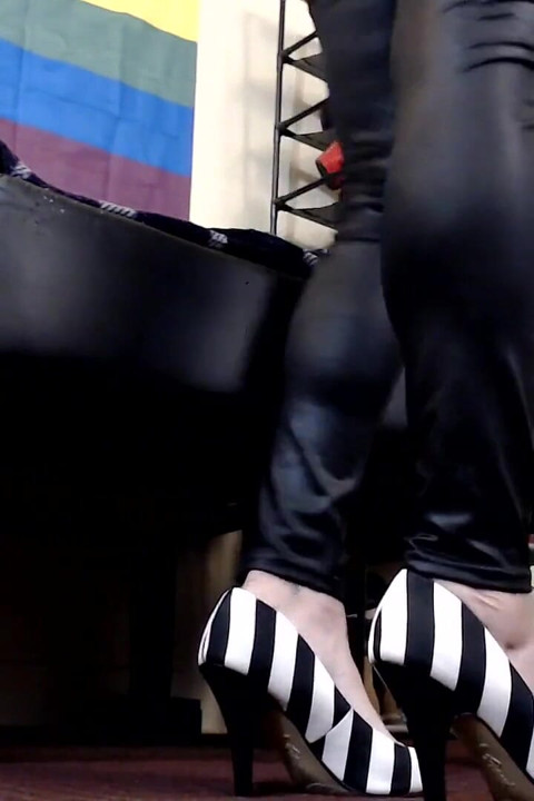 Worn high heels dangle shoe play
