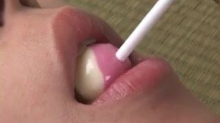 Beautiful Japanese girl licking a lollypop