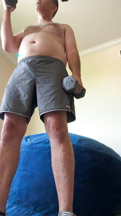 Lifting weights with my shirt off. My big sexy hairy chest is out in full force