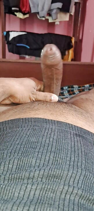 The desi young boy is fucking his thick long cock with his hands.