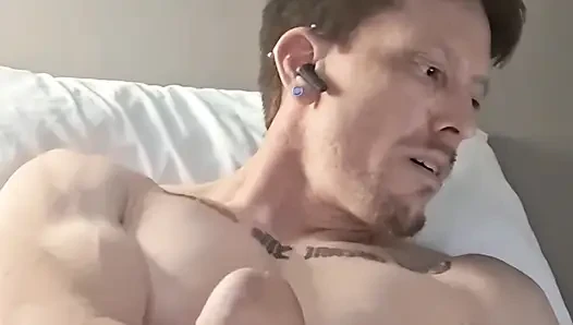 Kaslı adam tek başına mastürbasyon yapıyor ve büyük boşalma