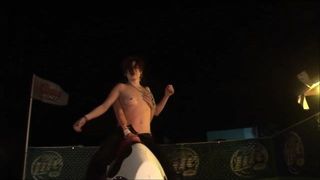 Topless mechanical bull riding girls