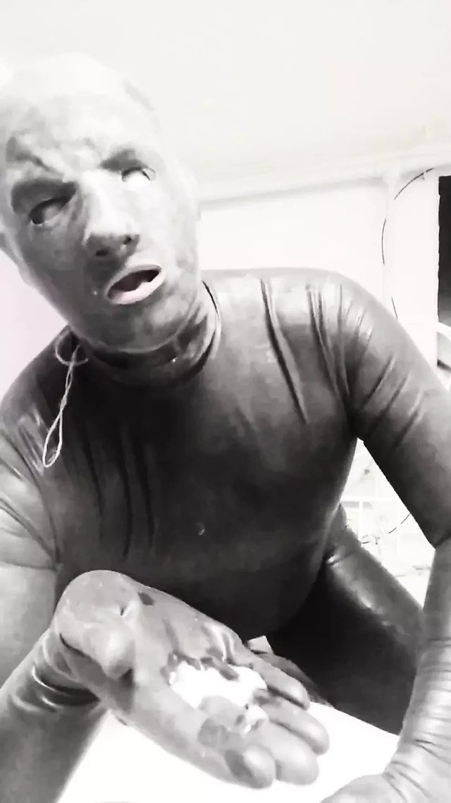 Latex guy jerks off his cock and cums in his hand