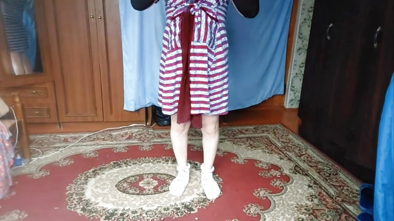 Prekrasan femboy drži šešir dok kosa puše na vjetru