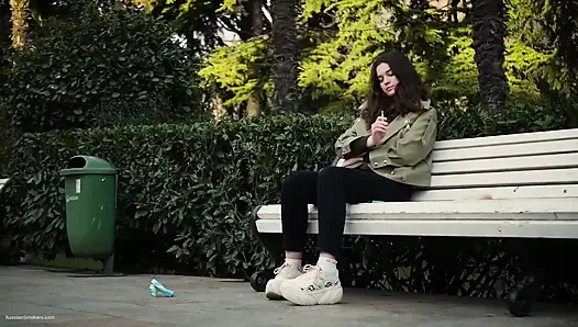 Young Brunette Is Taking an Unhurried Stroll with Allwhite 120mm Cigarette