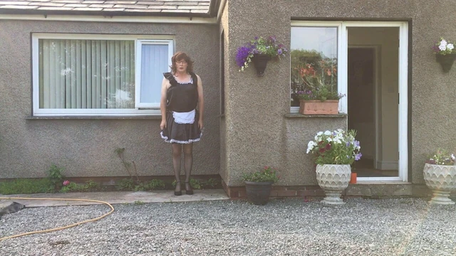 sissy maid neil in his maids uniform outside his house