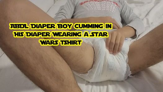 Abdl luierjongen komt klaar in zijn luier terwijl hij een Star Wars-t-shirt draagt