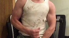 Muscular guy in dirty wifebeater flexing and blowing a load