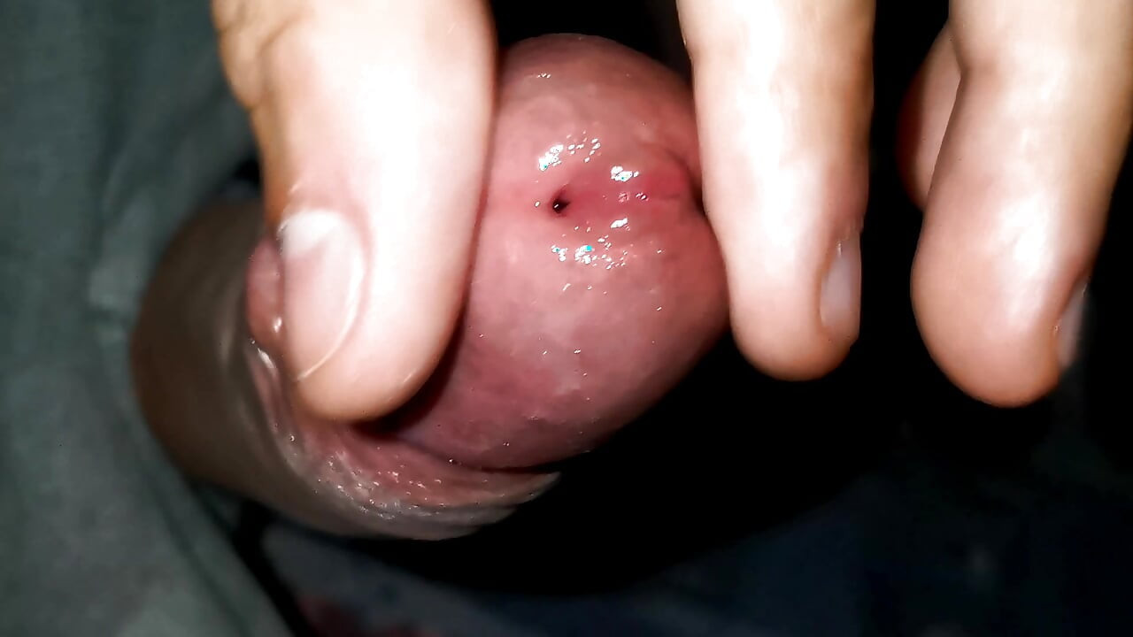 Playing with the head of a wet penis
