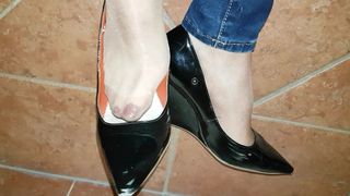 I piedi in nylon giocano con le unghie rosse