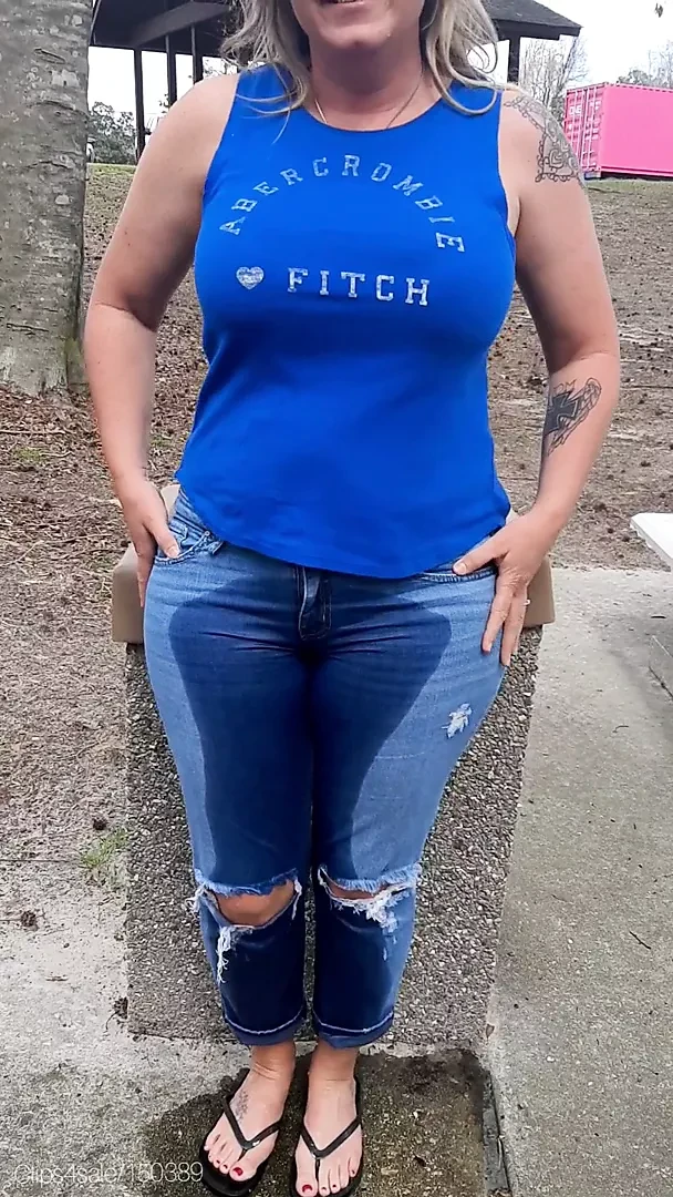 Woman wets jeans in park
