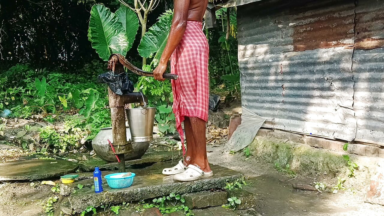 Desi young man bath Open place.