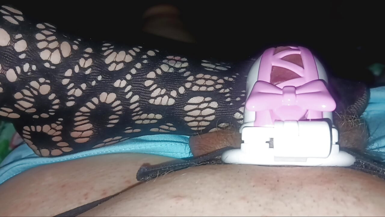 Playing with hubby in his pretty pink ribbon chastity.