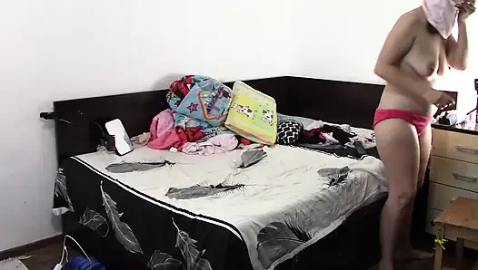 Sexy brunette doing naked chores around the house.